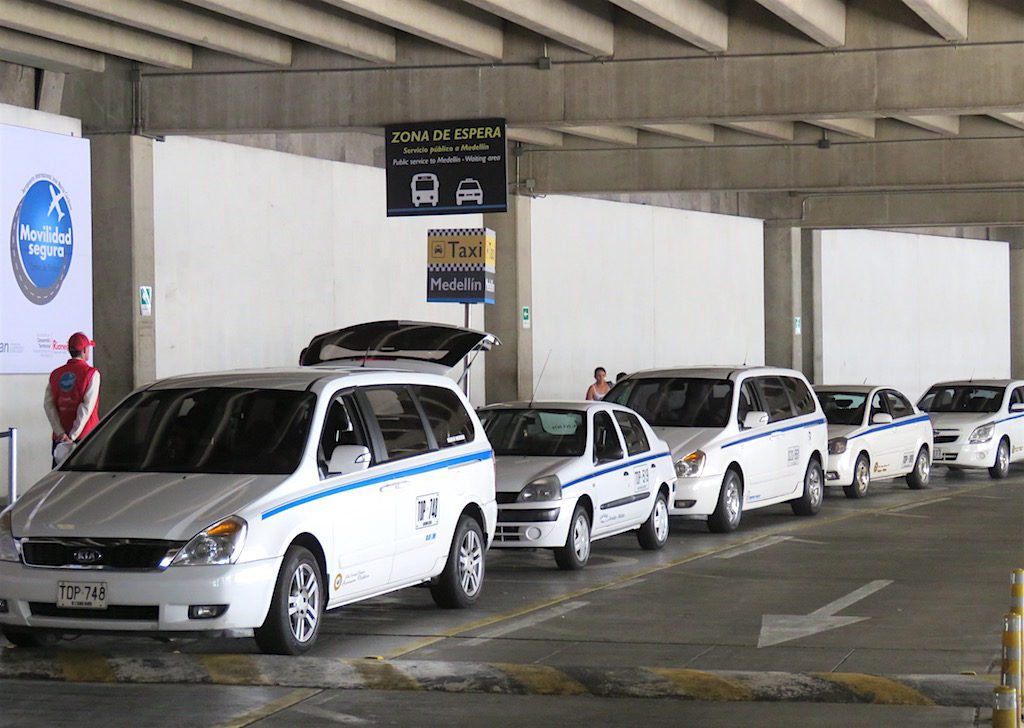 White airport taxis lined up at the airport